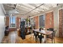 Open living area with exposed brick and wood floors at 114 W Adams St # 808, Phoenix, AZ 85003