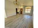 Living room featuring light walls, wood-look flooring, and a ceiling fan at 20411 N 99Th Dr, Peoria, AZ 85382