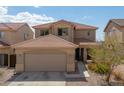 Two-story home with tan exterior and landscaped front yard at 23837 W Jefferson St, Buckeye, AZ 85396