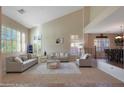 Bright living room with vaulted ceilings and comfy seating at 4497 N 152Nd Dr, Goodyear, AZ 85395