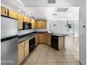 Kitchen with wood cabinets, granite countertops and stainless steel appliances at 1081 W 1St St # 7, Tempe, AZ 85281