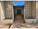 Front entry with decorative concrete block walls and a stone pathway at 5937 W Coolidge St, Phoenix, AZ 85033