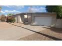 House exterior featuring a single-story home with attached garage and landscaping at 5937 W Coolidge St, Phoenix, AZ 85033