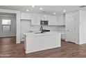 Modern white kitchen with island and stainless steel appliances at 2840 W La Mirada Dr, Laveen, AZ 85339