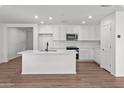 Modern white kitchen with island and stainless steel appliances at 2840 W La Mirada Dr, Laveen, AZ 85339