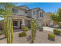 Two-story house with a two-car garage and cacti at 7715 S 69Th Ln, Laveen, AZ 85339