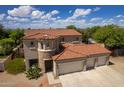 An aerial view showcasing a large two-story house with a three-car garage and nicely landscaped yard at 161 N Silverwood Dr, Casa Grande, AZ 85122