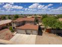 Two-story home with a three-car garage and tile roof at 161 N Silverwood Dr, Casa Grande, AZ 85122