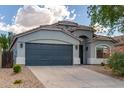 Gray house with a two-car garage and landscaping at 3847 W Yellow Peak Dr, San Tan Valley, AZ 85144