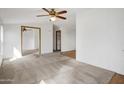 Open living room featuring carpeted floors and multiple ceiling fans at 535 S Alma School Rd # 45, Mesa, AZ 85210