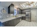 Modern kitchen featuring sleek dark cabinets, stainless steel appliances, and white countertops at 2124 E Osborn Rd, Phoenix, AZ 85016