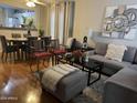 Living room features L-shaped sectional sofa and hardwood floors at 6862 W Gardenia Ave, Glendale, AZ 85303