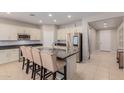 Modern kitchen with island, stainless steel appliances, and light cabinets at 17986 W Fulton St, Goodyear, AZ 85338