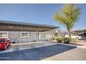 Condo exterior with carport, landscaping, and a light gray facade at 1050 S Stapley Dr # 52, Mesa, AZ 85204