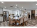 Modern kitchen with white cabinets, island, and stainless steel appliances at 6514 N 85Th Pl, Scottsdale, AZ 85250