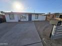 Single story home with blue door and landscaped yard at 206 N 5Th St, Avondale, AZ 85323