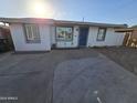 Single story home with blue door and landscaped yard at 206 N 5Th St, Avondale, AZ 85323