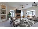 Virtually staged living room with fireplace and seating area at 2223 E Branham Ln, Phoenix, AZ 85042