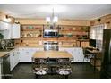 Open kitchen with white cabinets, wood accents, and a kitchen island at 90 W Yavapai St # 8, Wickenburg, AZ 85390