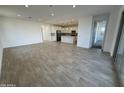 Spacious living room with wood-look tile flooring and open concept layout at 5338 W Manzanita Dr, Glendale, AZ 85302