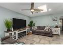 Cozy living room featuring a fireplace and large TV at 4628 E Holly St, Phoenix, AZ 85008