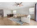 Spacious living room with L-shaped sofa and wood flooring at 10829 W Buchanan St, Avondale, AZ 85323