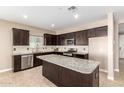 Spacious kitchen featuring granite island and stainless steel appliances at 37784 W San Sisto Ave, Maricopa, AZ 85138