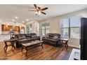 Living room with leather sofas, wood floors, and a ceiling fan at 2425 W Bronco Butte Trl # 1008, Phoenix, AZ 85085