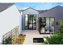 Private courtyard with glass doors and a water feature at 6850 E Joshua Tree Ln, Paradise Valley, AZ 85253