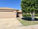 Attached garage with a long driveway and landscaping at 10509 W Tropicana Cir, Sun City, AZ 85351