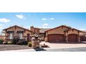 Two-story home with three-car garage and stone accents at 10683 E Saddle Blanket Trl, Gold Canyon, AZ 85118