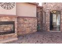Exterior features a stone fireplace and wrought iron gate at 10683 E Saddle Blanket Trl, Gold Canyon, AZ 85118