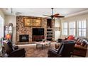 Spacious living room with a stone fireplace and built-in entertainment center at 10683 E Saddle Blanket Trl, Gold Canyon, AZ 85118