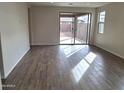 Bright and airy living room with tile flooring and sliding glass door to backyard at 17841 W Blue Sky Dr, Surprise, AZ 85387