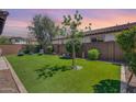 Landscaped backyard with artificial turf and seating area at 4707 S Avitus Ln, Mesa, AZ 85212