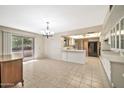 Bright kitchen with white cabinets, black appliances, and tile floor at 12807 W Mesa Verde Dr, Sun City West, AZ 85375