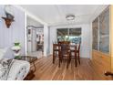 Dining area with wood floors, a table with four chairs, and a wooden hutch at 201 S Greenfield Rd # 216, Mesa, AZ 85206