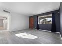 Gray plank walls, wood-look floors, and a wood door at 8606 N 32Nd Ave, Phoenix, AZ 85051