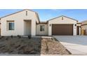 Modern home's front exterior with two-car garage and desert landscaping at 37735 W Padilla St, Maricopa, AZ 85138