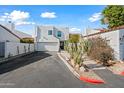 Charming two-story home with white stucco, attached garage, and desert landscaping at 5810 N 8Th Pl, Phoenix, AZ 85014