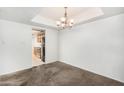 Simple dining area with carpeted floors and a chandelier at 12222 N Paradise Village S Pkwy # 339, Phoenix, AZ 85032