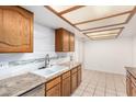 Kitchen features granite countertops, wood cabinets, and a double sink at 12222 N Paradise Village S Pkwy # 339, Phoenix, AZ 85032
