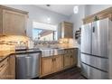 Updated kitchen featuring stainless steel sink and wood cabinets at 9023 S Dean Rd, Buckeye, AZ 85326