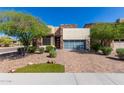 Modern home exterior with stone and glass accents at 12794 W Burnside Trl, Peoria, AZ 85383