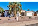 Ranch style home with a two-car garage and mature landscaping at 5312 E Evans Dr, Scottsdale, AZ 85254