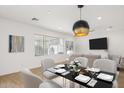 Bright dining area with modern light fixture and seating for six at 6412 N 17Th Pl, Phoenix, AZ 85016