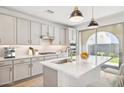 Modern kitchen with island, stainless steel appliances, and backyard access at 6412 N 17Th Pl, Phoenix, AZ 85016