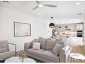 Open living room features neutral colored couch and kitchen views at 6412 N 17Th Pl, Phoenix, AZ 85016