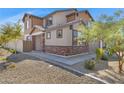 Two-story home with brick and siding exterior, landscaping, and a walkway at 10763 W Beatrice St, Avondale, AZ 85323