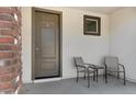 Small front patio with two chairs and a table at 10763 W Beatrice St, Avondale, AZ 85323